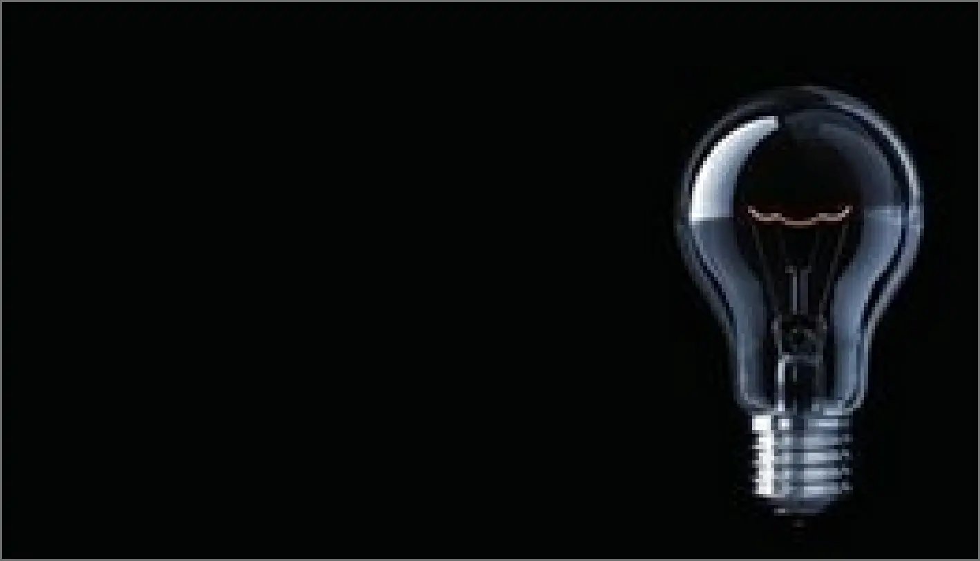 dim lightbulb with black background
