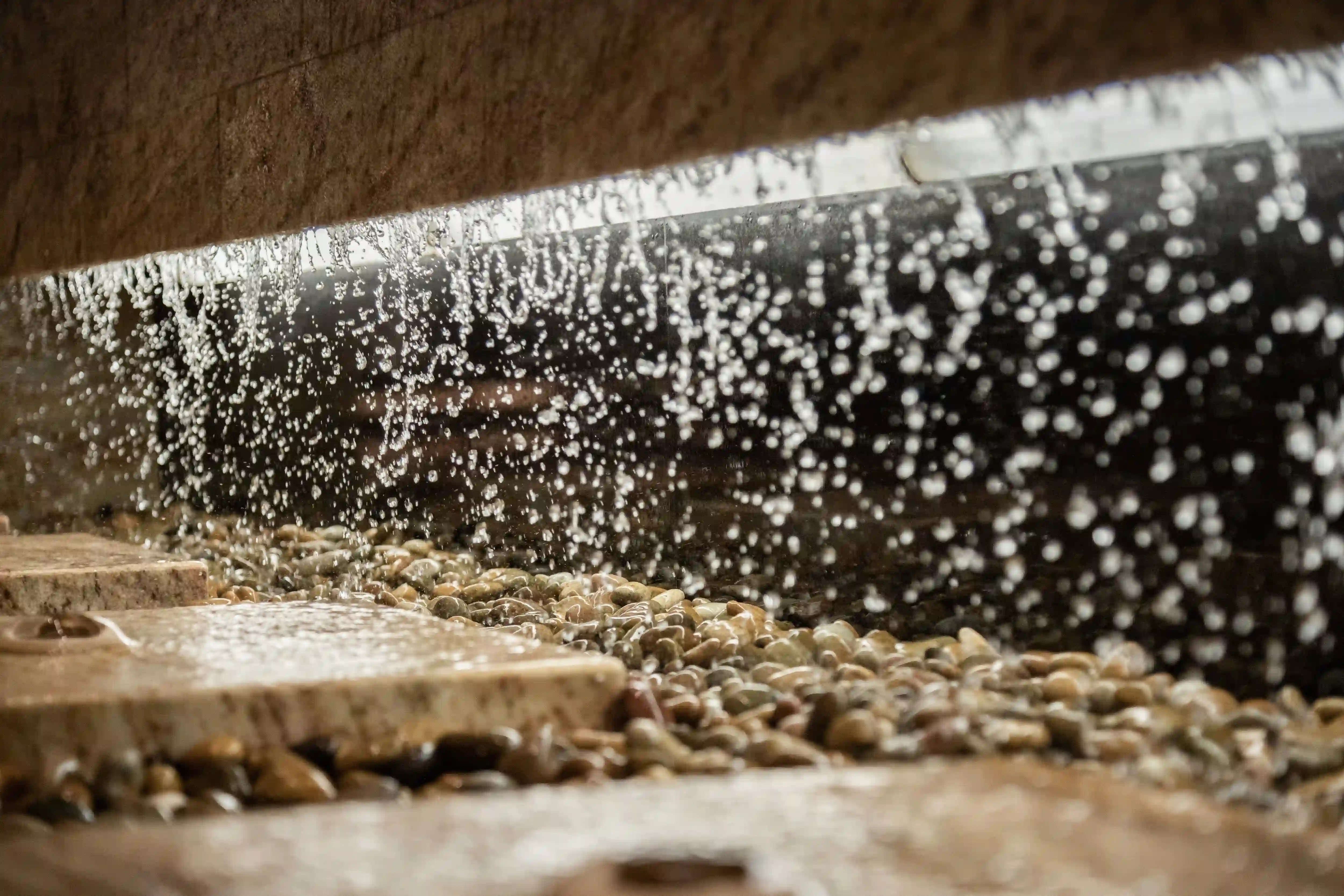 water flowing into the pebbles